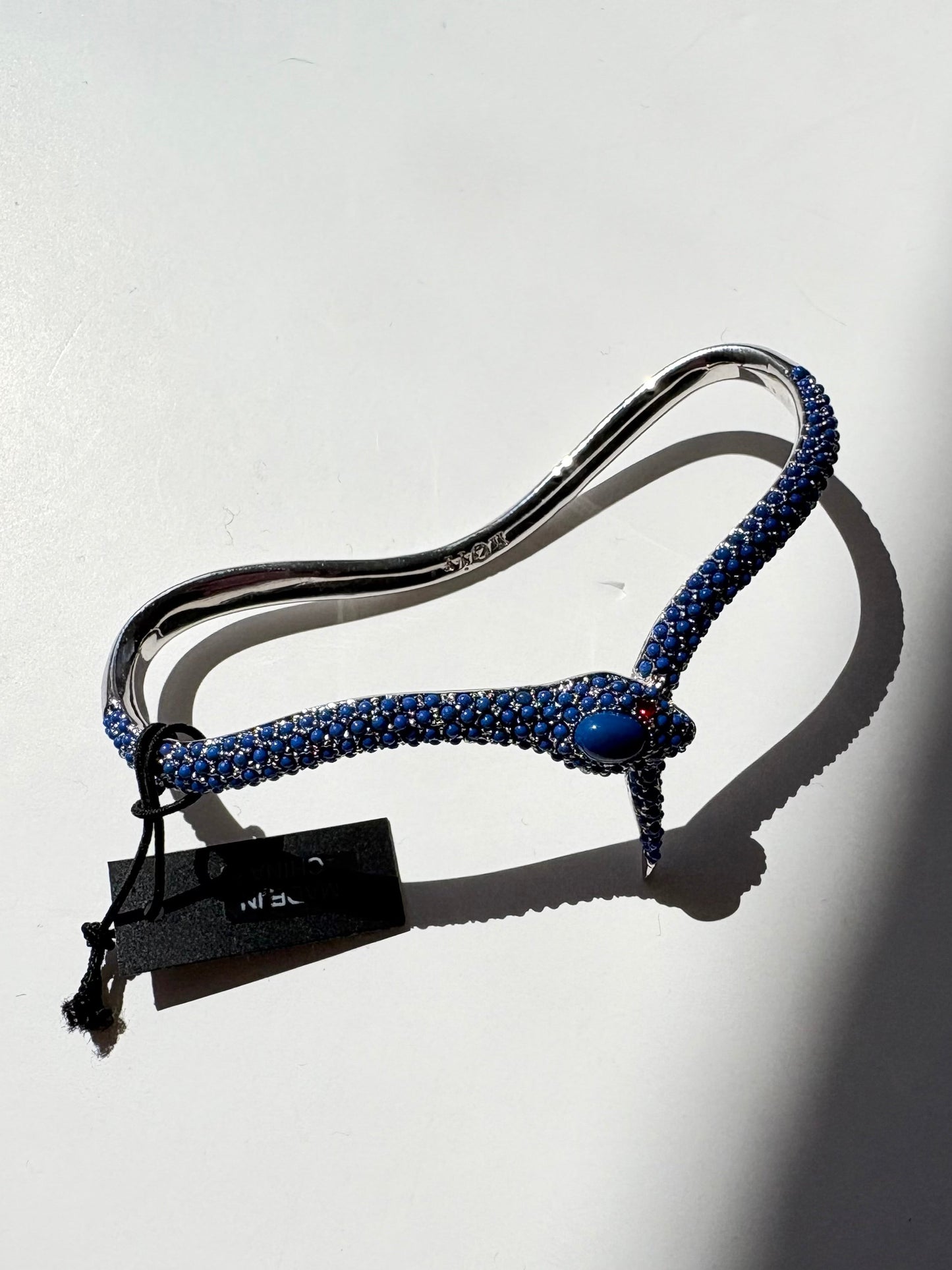 Noir NYC red eyes snake palm cuff