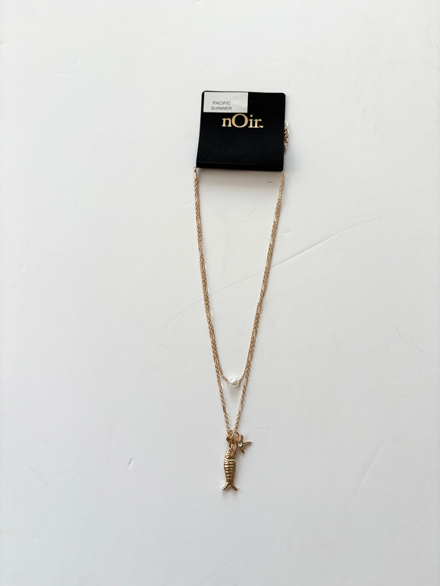Noir NYC pacific sun charm pendant necklace